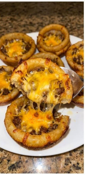 Finished crispy cheeseburger onion ring cups with melted cheddar cheese and ground beef