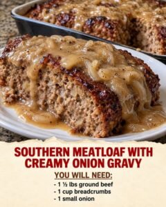 Southern meatloaf slice topped with creamy onion gravy and softened sliced onions